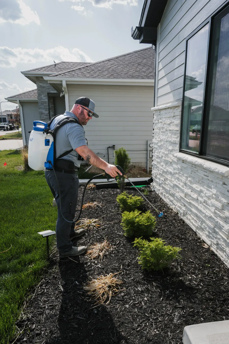 Scott's Pest Control technician servicing an Omaha property